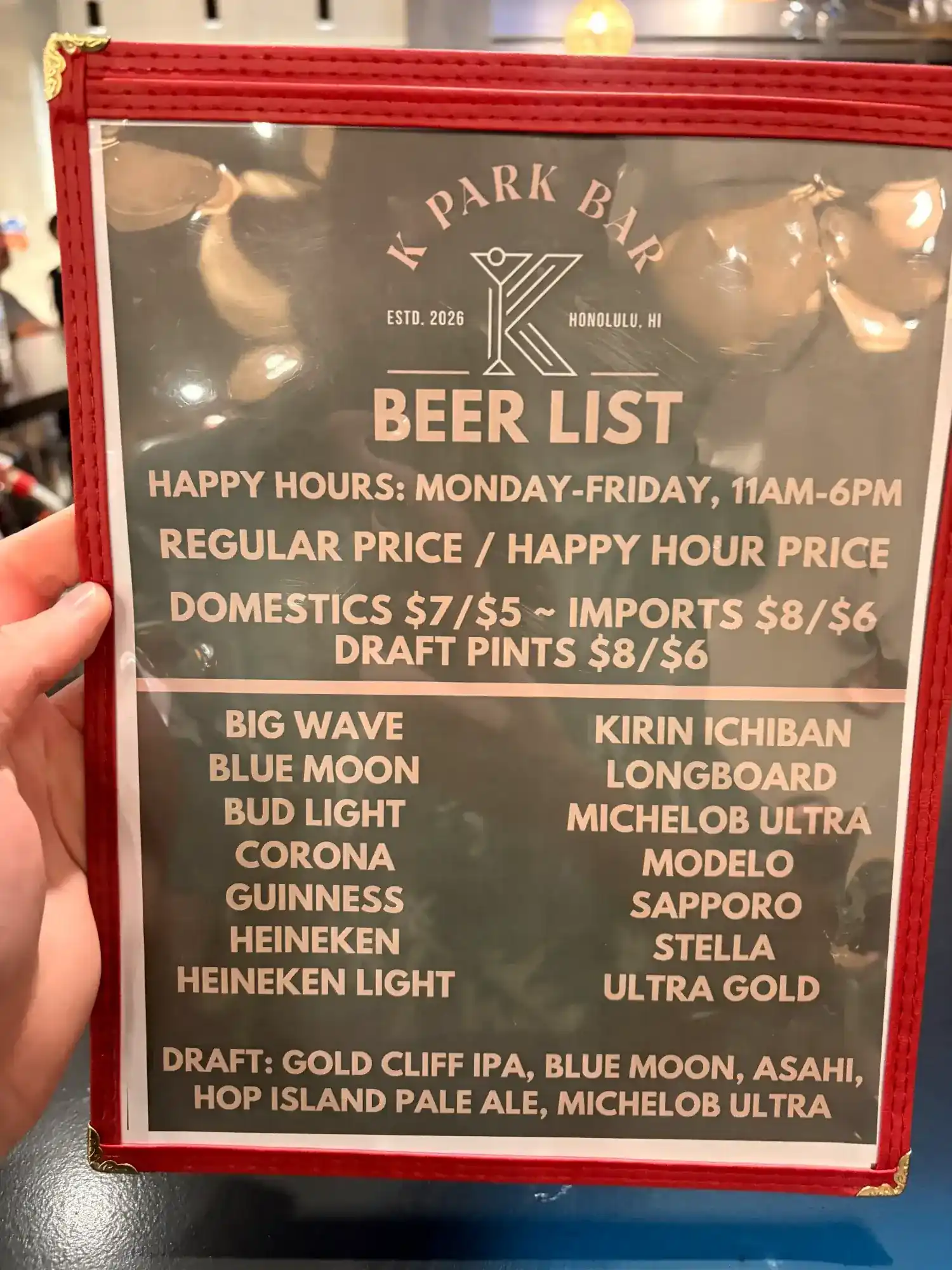 K Park Bar beer list menu showing happy hour prices Monday through Friday 11am to 6pm with domestic and import options