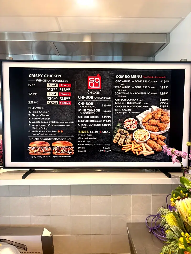 Soul Chicken digital menu board showing Korean fried chicken prices and combo options at Midtown Eats food hall