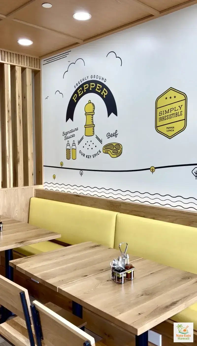 Pepper Lunch Hawaii interior with Freshly Ground Pepper mural and yellow booths