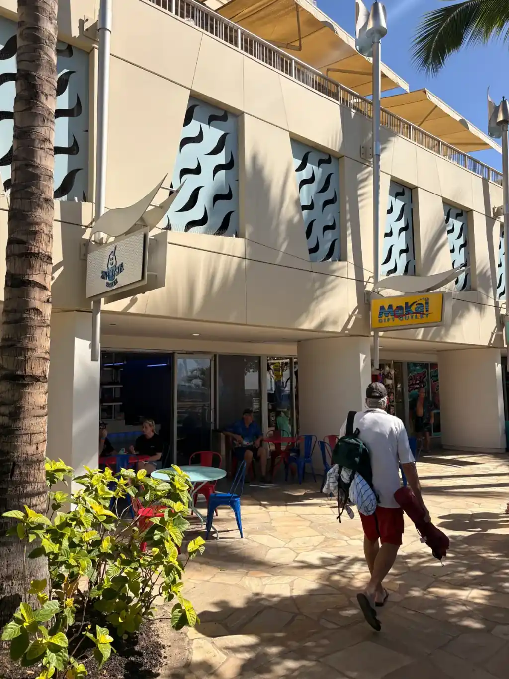 Sin Ice Stir storefront with customers enjoying shave ice at colorful outdoor tables in Waikiki