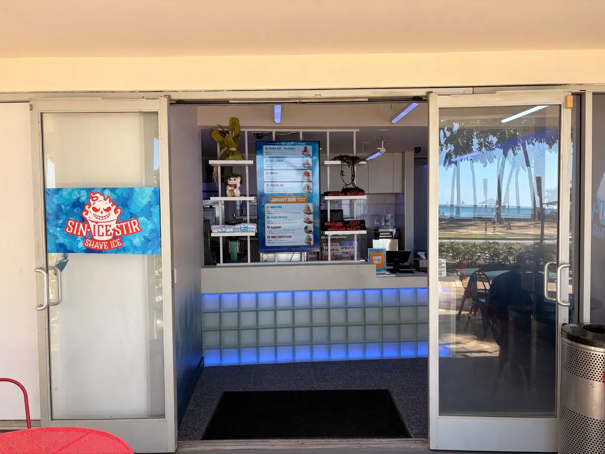 Sin Ice Stir shave ice shop storefront entrance with blue neon lighting on Kalakaua Avenue in Waikiki