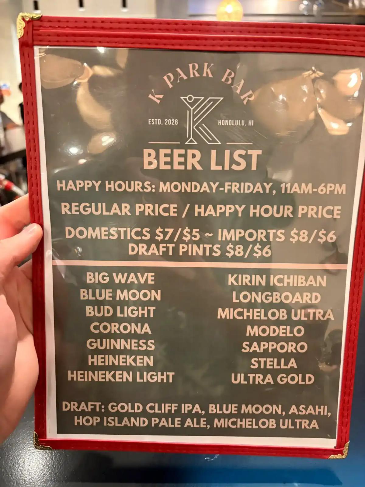 K Park Bar beer list menu showing happy hour prices Monday through Friday 11am to 6pm with domestic and import options
