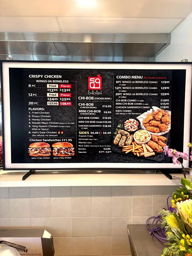 Soul Chicken digital menu board showing Korean fried chicken prices and combo options at Midtown Eats food hall